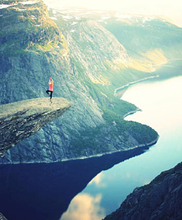 Person Standing on Edge of Cliff